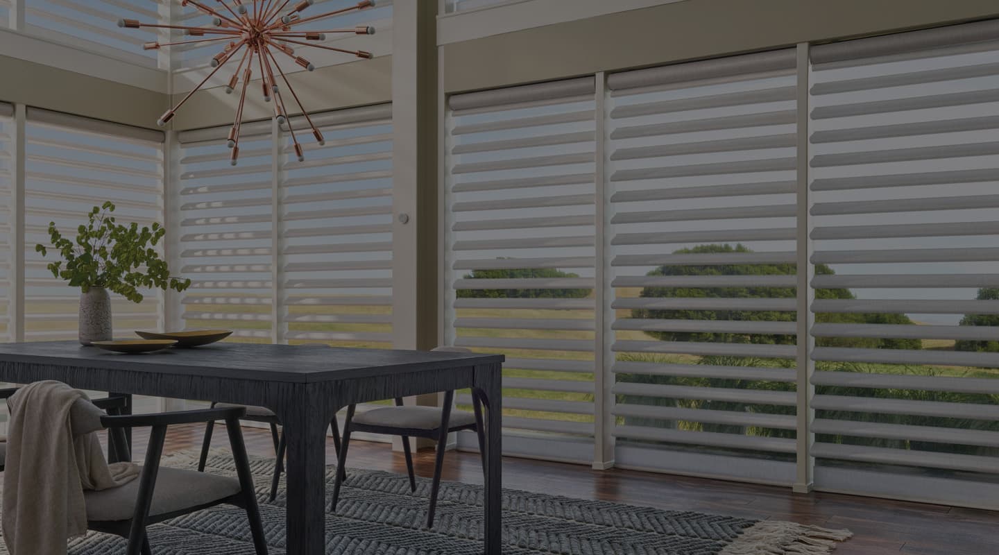 A sunlit Colorado living room with custom Hunter Douglas window treatments