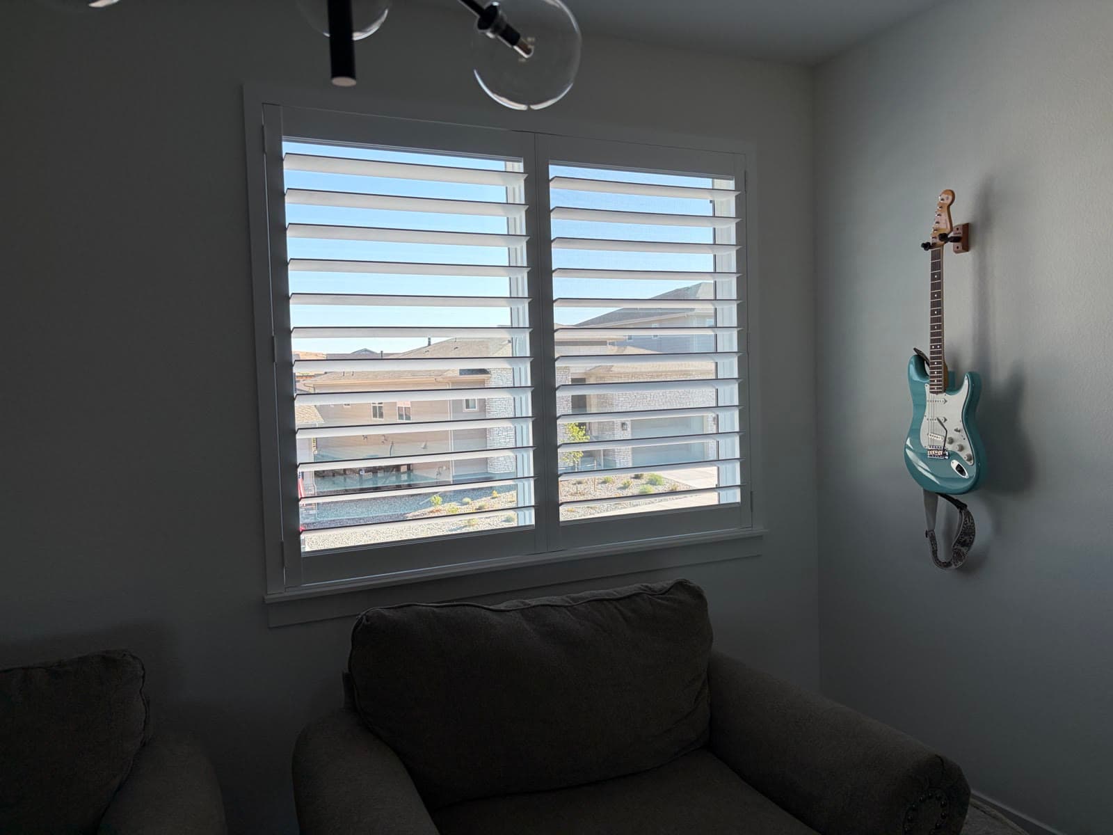 NewStyle® shutters tilted for light and privacy in a sitting room