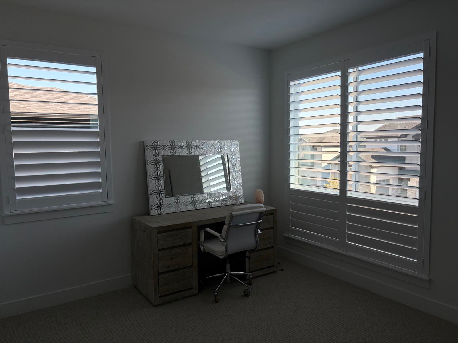 NewStyle® shutters on two office windows facing the neighboring homes
