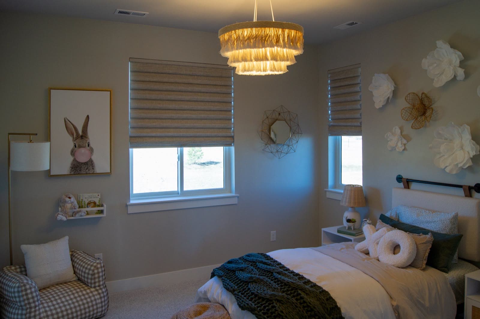 Woven wood Roman shades in a child's bedroom with a bubblegum bunny print