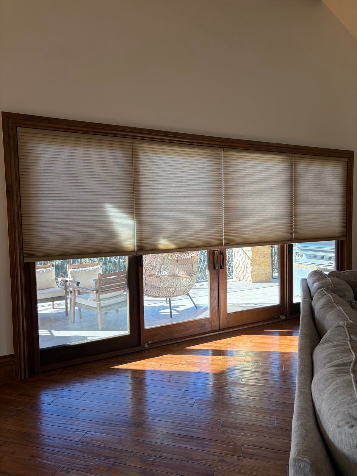 Cellular honeycomb shades fitted across a sliding patio door