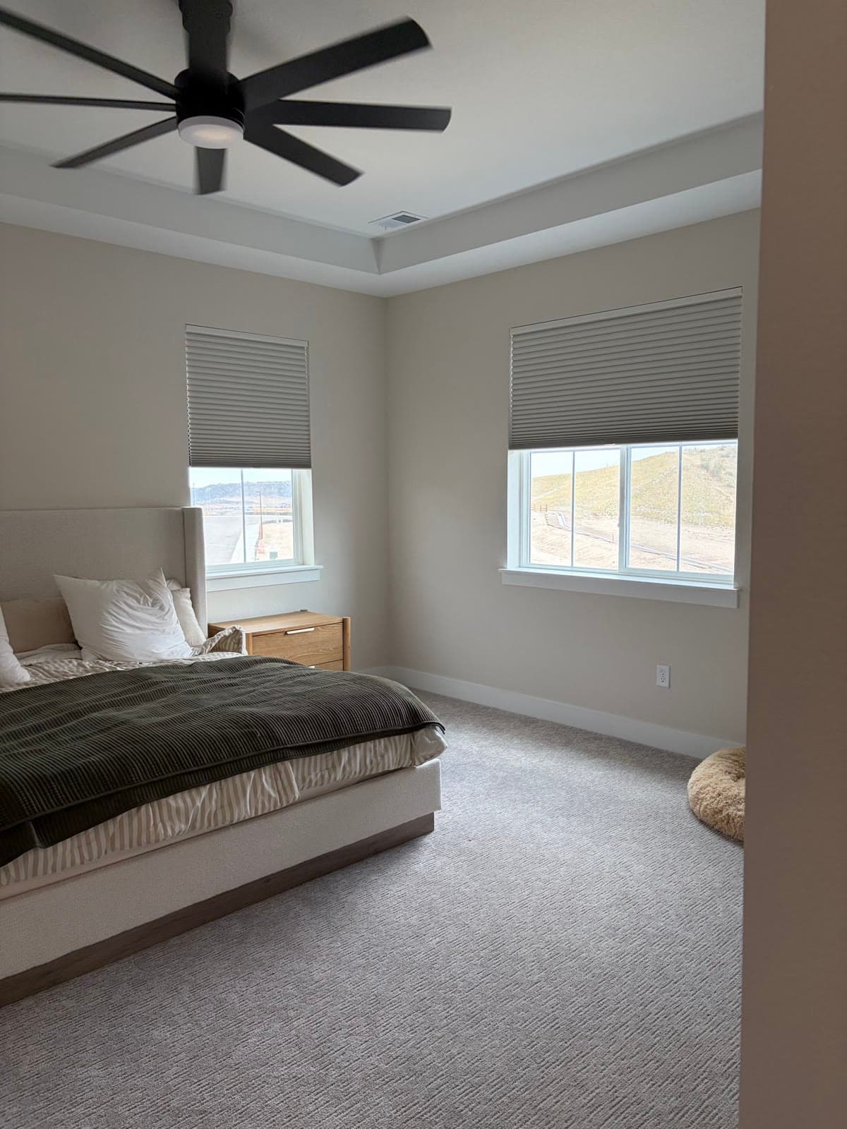Room-darkening cellular shades in a bedroom overlooking Colorado open space