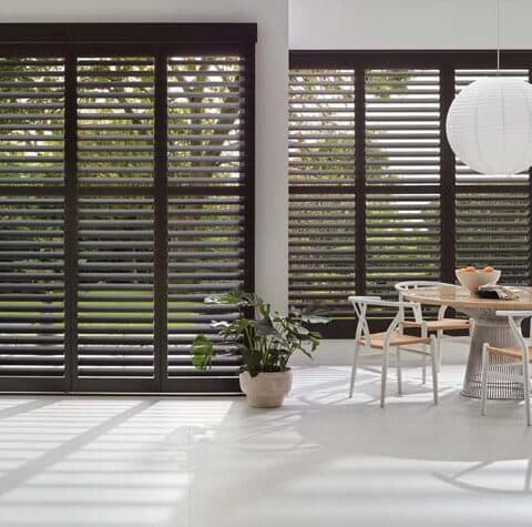 Bi-fold track shutters opening a kitchen
